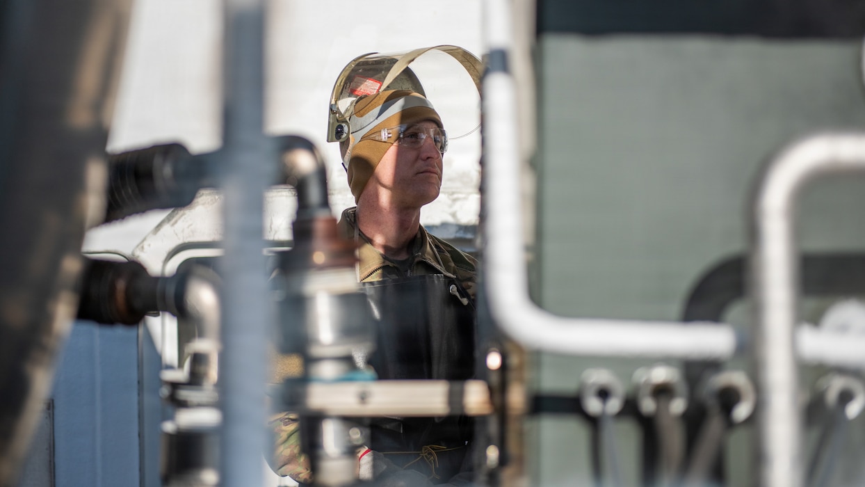 Airman monitoring gauges on truck