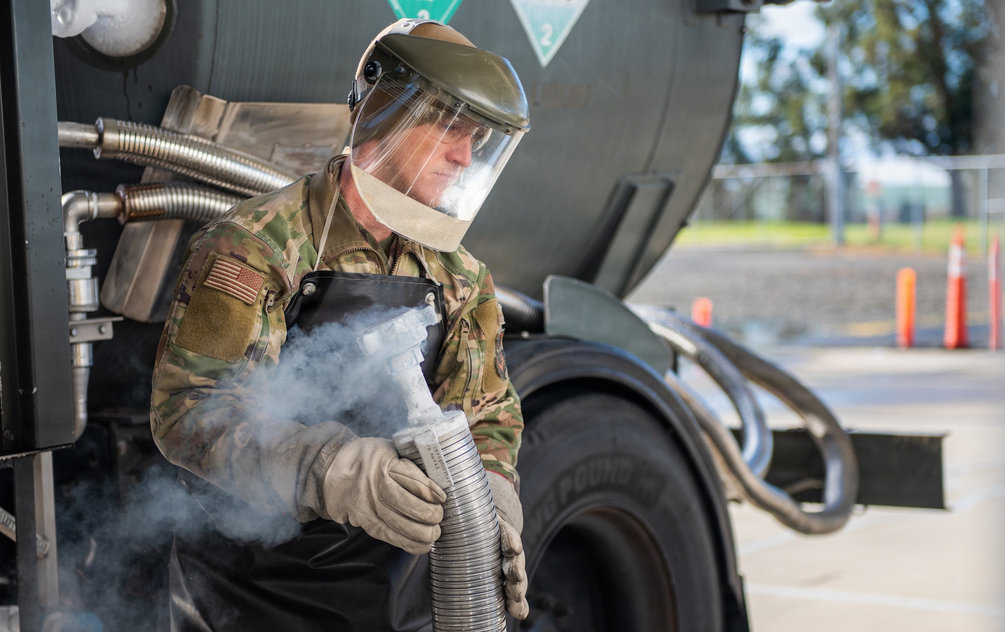 Airman detaches hose from truck.