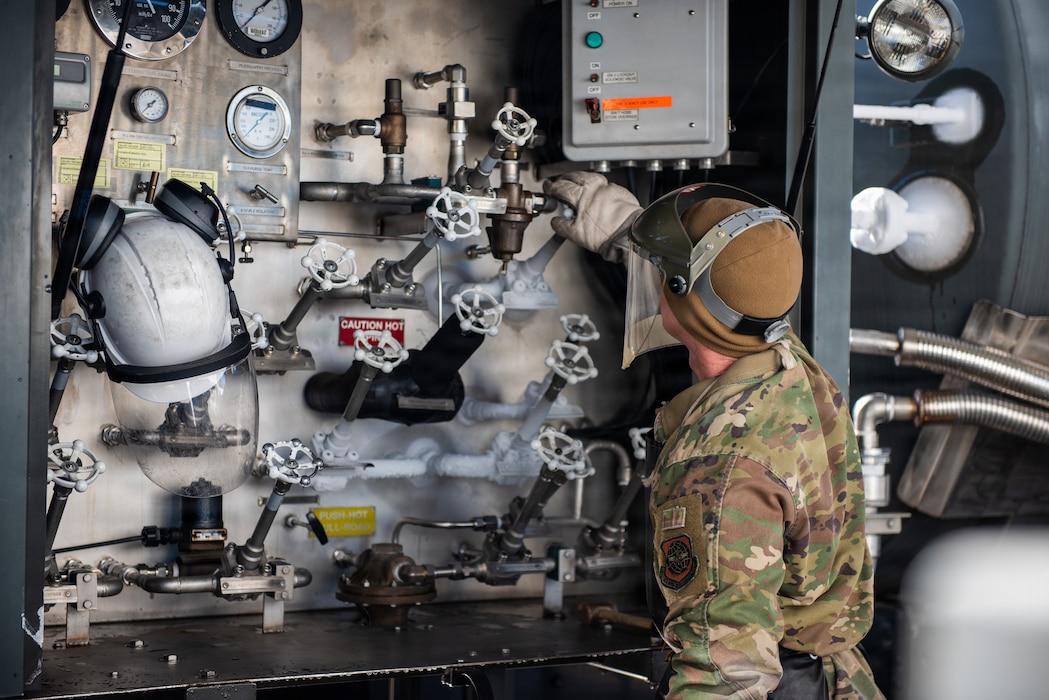 Airman operates control on fuel truck