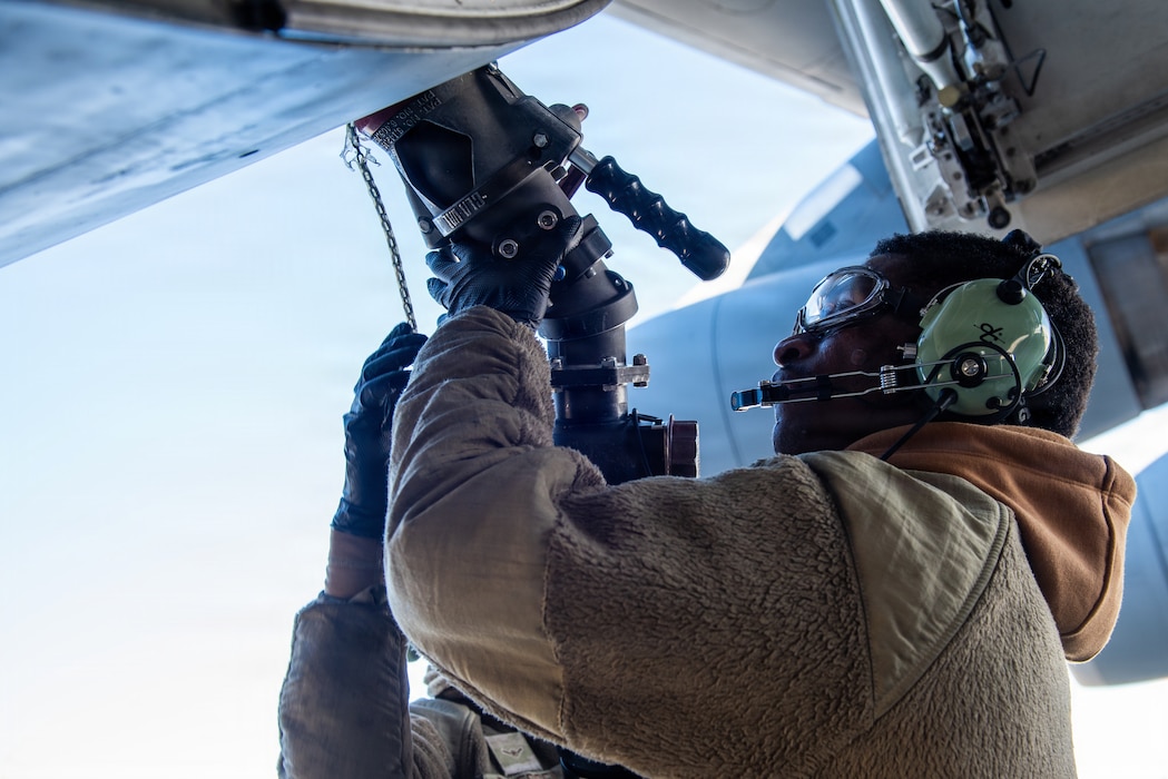 Airmen connect fuel hose to aircraft