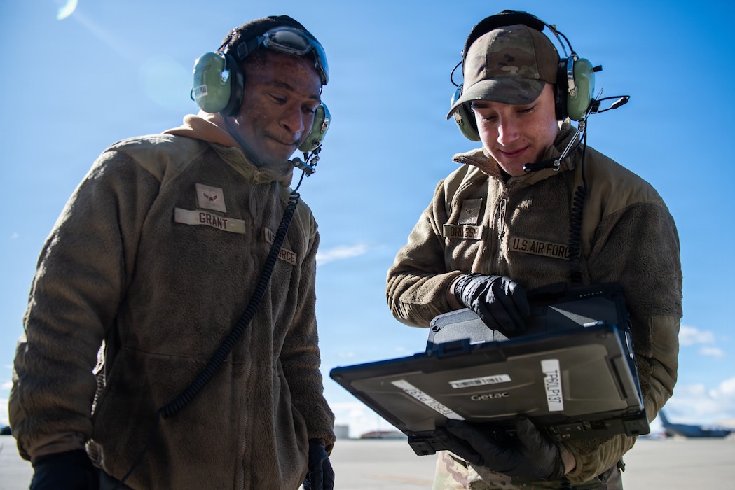 Airmen review documents on the flight line