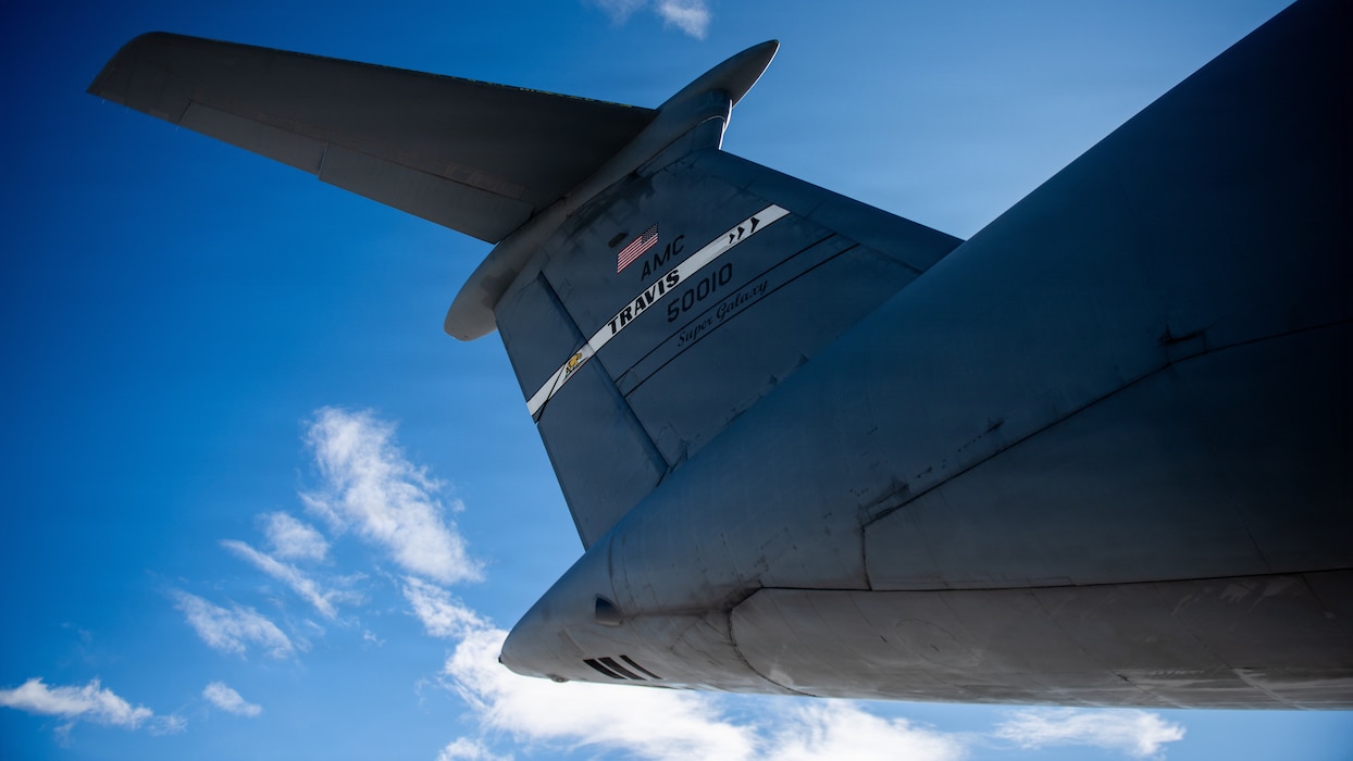 The tail of an aircraft with the sky in the background