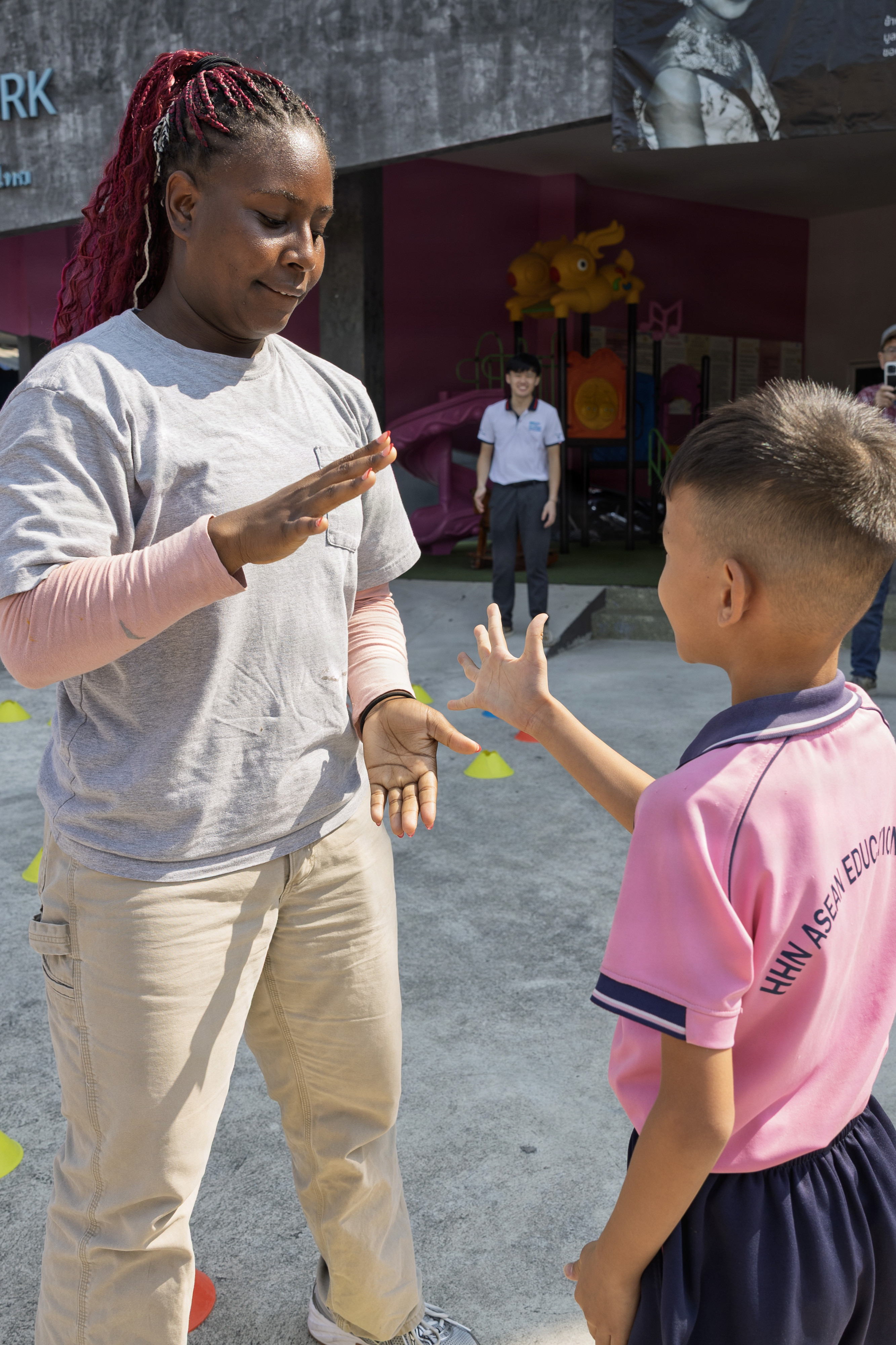 PATTAYA, Thailand — Civilian mariner Jalen Douglas, 3rd Mate, assigned to expeditionary fast transport ship USNS City of Bismarck (T-EPF 9), interacts with a student during a community outreach event at the Learning Center of the Human Help Network Foundation in Pattaya, Thailand, Jan. 27, 2026. (Photo by Grady T. Fontana)