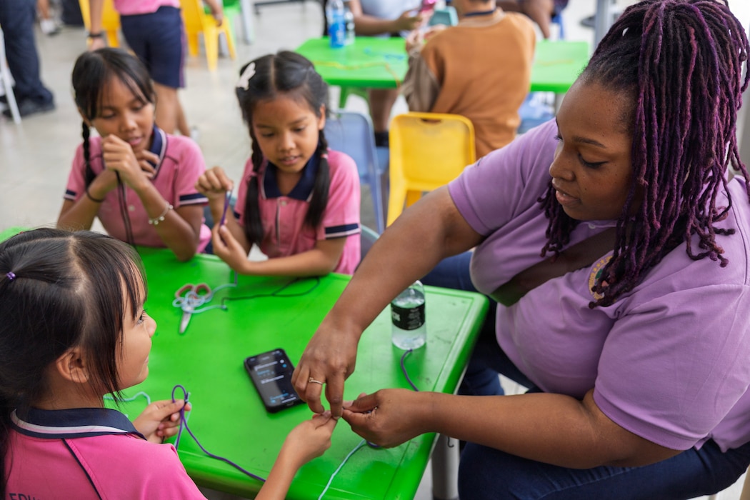 Civil service mariner Johnisha Scales, yeoman storekeeper, assigned to expeditionary fast transport ship USNS City of Bismarck (T-EPF 9), interacts with students during a community outreach event at the Learning Center of the Human Help Network Foundation in Pattaya, Thailand, Jan. 27, 2026.