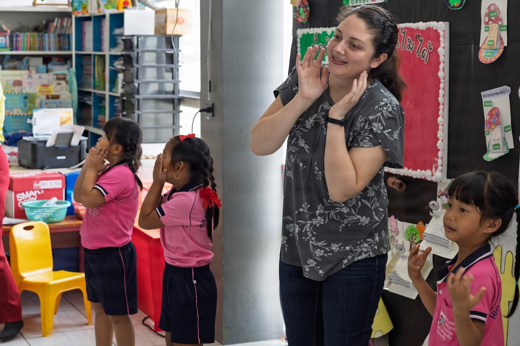 U.S. Navy Reserve Lt. Nicole Poolman, Military Sealift Command, Navy Reserve Expeditionary Port Unit Atlantic, plays with kids of the Learning Center, Human Help Network, during a community relations event at Pattaya, Thailand, Feb. 16, 2026.