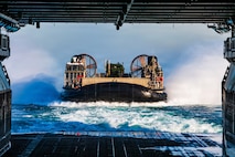 A U.S. Navy landing craft, air cushion, assigned to Assault Craft Unit 5, enters the well deck of Wasp-class amphibious assault ship USS Boxer (LHD 4) during launch and recovery operations, Feb. 23, 2026. Boxer, flagship of the Boxer Amphibious Ready Group, is underway with the 11th MEU in the U.S. 3rd Fleet area of operations conducting integrated training that enhances warfighting capability and tactical proficiency. (U.S. Navy photo by Mass Communication Specialist Seaman Apprentice Sailor O’Rear)