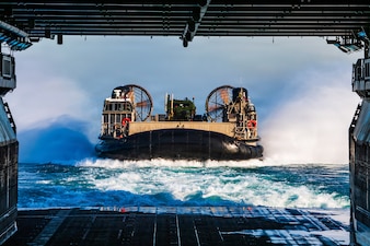 A U.S. Navy landing craft, air cushion, assigned to Assault Craft Unit 5, enters the well deck of Wasp-class amphibious assault ship USS Boxer (LHD 4) during launch and recovery operations, Feb. 23, 2026. Boxer, flagship of the Boxer Amphibious Ready Group, is underway with the 11th MEU in the U.S. 3rd Fleet area of operations conducting integrated training that enhances warfighting capability and tactical proficiency. (U.S. Navy photo by Mass Communication Specialist Seaman Apprentice Sailor O’Rear)