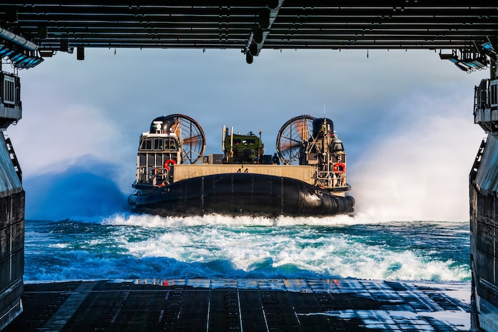 A U.S. Navy landing craft, air cushion, assigned to Assault Craft Unit 5, enters the well deck of Wasp-class amphibious assault ship USS Boxer (LHD 4) during launch and recovery operations, Feb. 23, 2026. Boxer, flagship of the Boxer Amphibious Ready Group, is underway with the 11th MEU in the U.S. 3rd Fleet area of operations conducting integrated training that enhances warfighting capability and tactical proficiency. (U.S. Navy photo by Mass Communication Specialist Seaman Apprentice Sailor O’Rear)