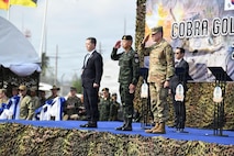 Sean K. O'Neill, U.S. Ambassador to Thailand, Gen. Ukris Boontanondha, Chief of Defense Forces Thailand, and U.S. Army Lt. Gen. Matthew W. McFarlane, the Commanding General of America’s First Corps and Joint Base Lewis-McChord, Wash., render a salute at the opening ceremony of Exercise Cobra Gold in Rayong Province, Thailand, Feb. 24, 2026.