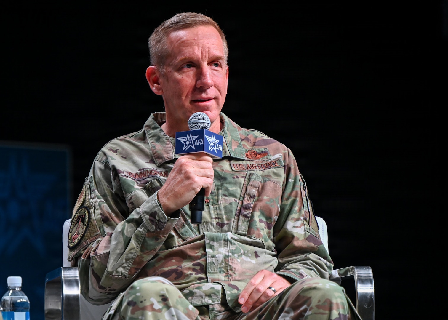 A military member speaks at a panel.