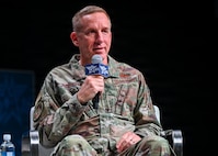 A military member speaks at a panel.