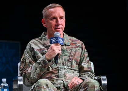 A military member speaks at a panel.