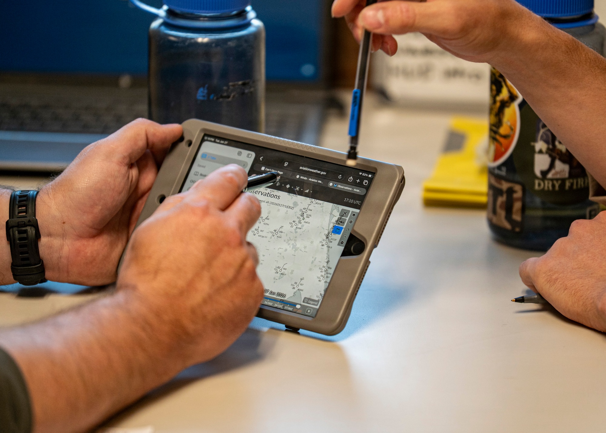 U.S. Coast Guard Lt. James Cozby, Training Air Wing (TW-5) FIVE instructor pilot, left, and U.S. Marine Corps 2nd Lt. Alex Hardin, student naval aviator assigned to the “Shooters” Training Squadron (VT) 6, go over details of their upcoming flight at Avon Park Air Force Range, Florida, Jan. 27, 2026. Students trained in the T-6B Texan II as part of the early phase of undergraduate naval flight training. (U.S. Air Force photo by Senior Airman Leonid Soubbotine)