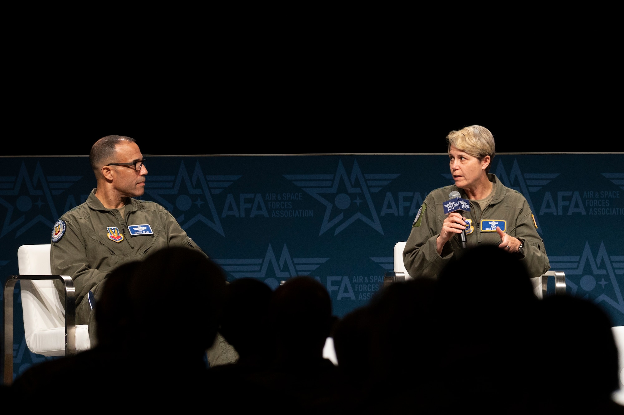 U.S. Air Force Gen. Adrian Spain, commander of Air Combat Command, left, joins a panel on improving readiness for peer conflict with Lt. Gen. Rebecca Sonkiss, interim commander of Air Mobility Command, right, at the 2026 Air & Space Forces Association Warfare Symposium in Aurora, Colorado, Feb. 24, 2026. AMC provides the global airlift, aerial refueling and aeromedical evacuation capabilities that enable ACC to project air combat superiority anywhere in the world. (U.S. Air Force photo by Capt. Christian Little)
