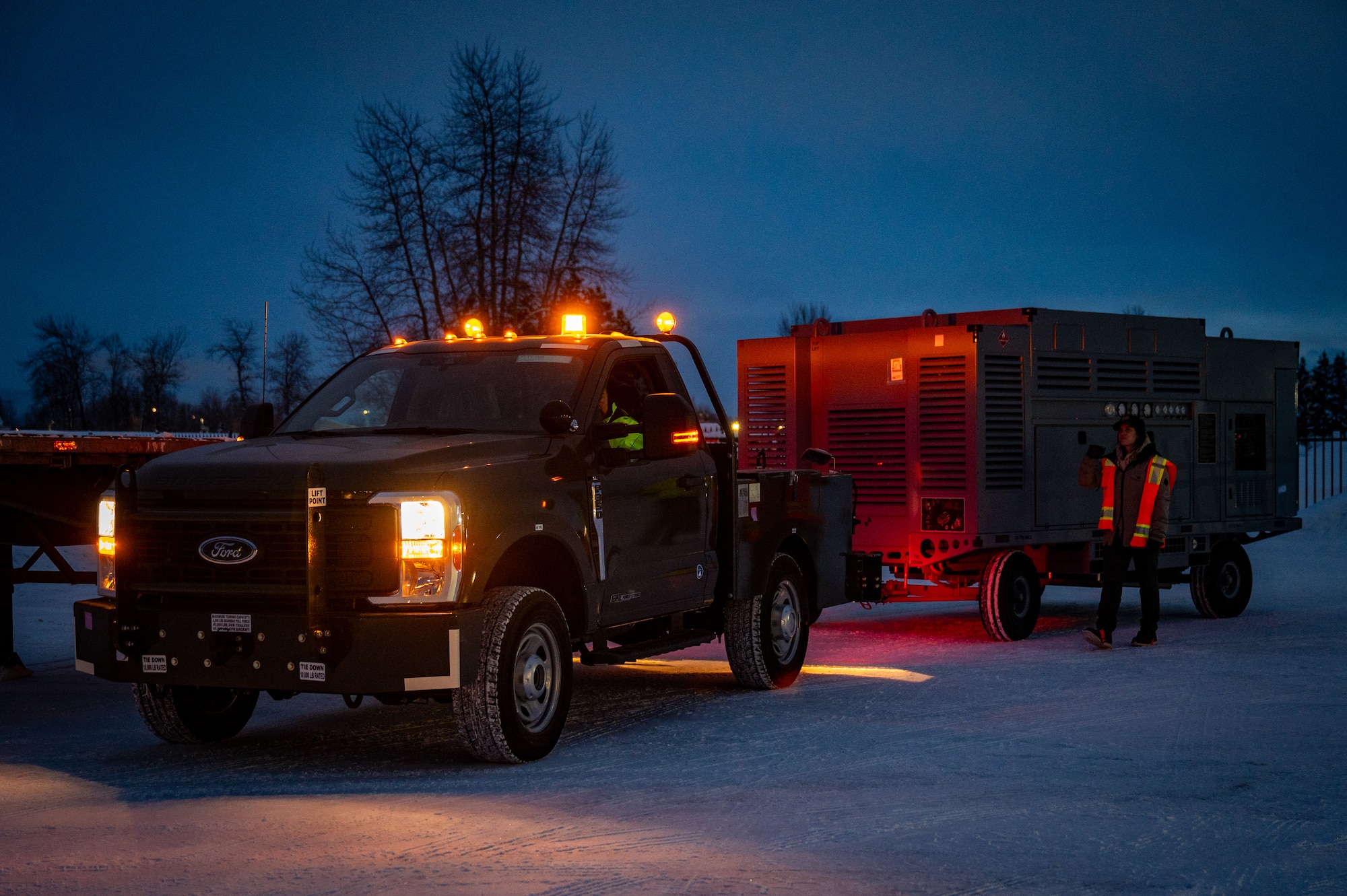 U.S. Air Force contractors assigned to the 673rd Logistics Readiness Squadron, haul Prepositioned Warfighting Materiel equipment at Joint Base Elmendorf-Richardson, Alaska, Jan. 15, 2026. The materiel consists of rapidly deployable equipment sets that enable facility establishment, communications, and aircraft sortie generation in austere environments, thereby reducing the need for long-distance airlift of supplies. (U.S. Air Force photo by Senior Airman Hunter Hites)