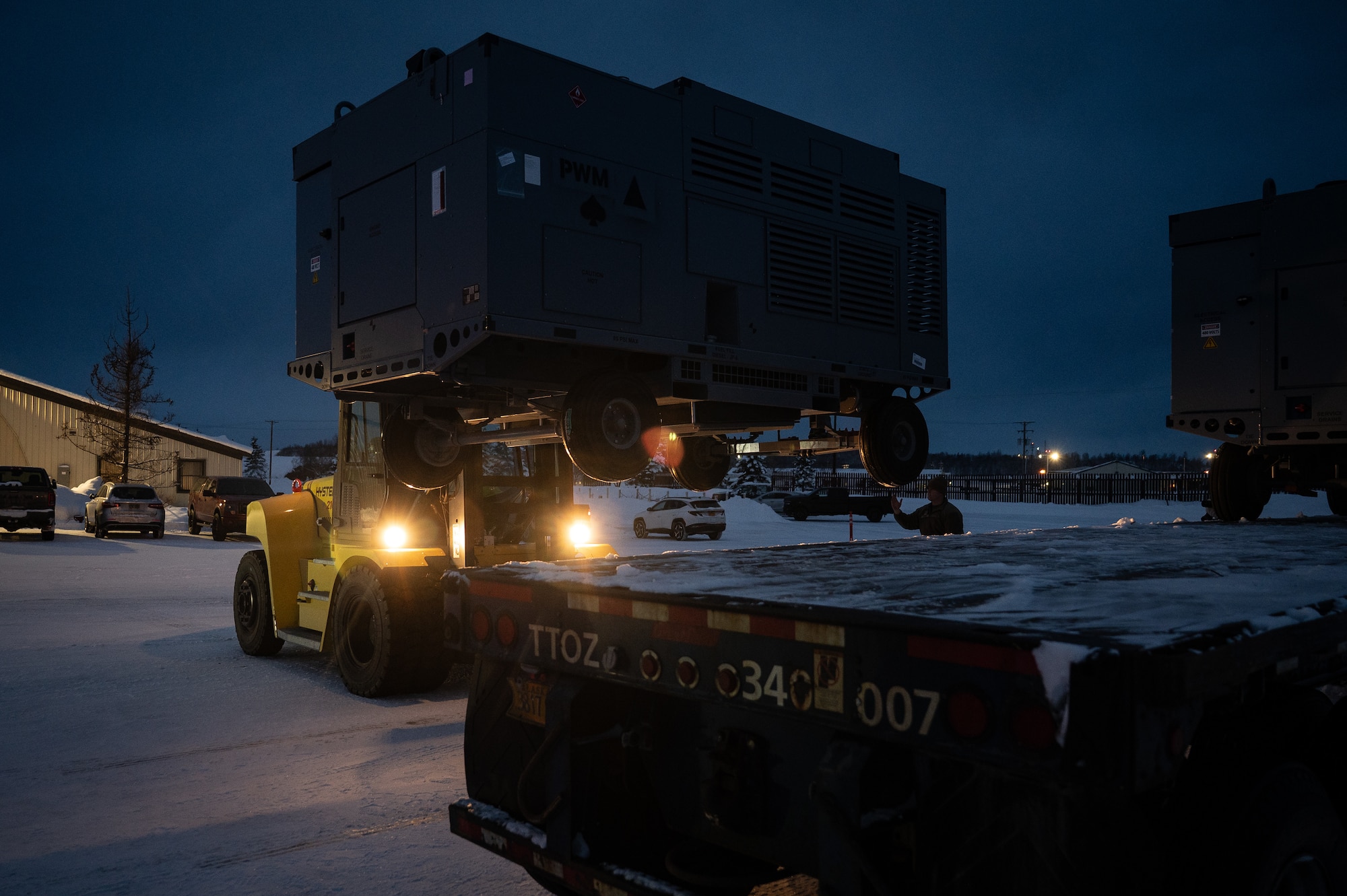 U.S. Air Force Airman Aiden Gonzales, 773d Logistics Readiness Squadron ground transportation support operator, operates a forklift during a Prepositioned Warfighting Materiel movement at Joint Base Elmendorf-Richardson, Alaska, Jan. 15, 2026. The materiel consists of rapidly deployable equipment sets that enable facility establishment, communications, and aircraft sortie generation in austere environments, thereby reducing the need for long-distance airlift of supplies. (U.S. Air Force photo by Senior Airman Hunter Hites)