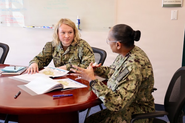 TWENTYNINE PALMS, Calif. (Feb. 19, 2026) — Lt. Gillian Gutierres, left, participates in a one-on-one meeting with commanding officer Capt. Janiese Cleckley during the Commanding Officer for a Day program at Navy Medicine Readiness and Training Command Twentynine Palms. The initiative provides junior officers firsthand exposure to command-level leadership and decision-making. (U.S. Navy photo by Christopher Jones, NMRTC Twentynine Palms public affairs officer)