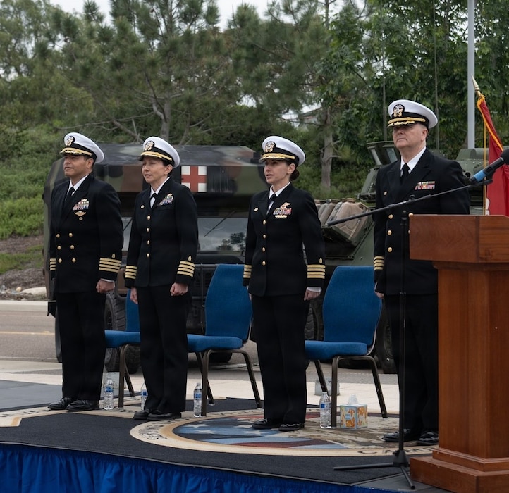 Navy Capt. Victor Diaz (left), deputy commander, Naval Medical Forces Pacific; Capt. Cheri Smiley, incoming commanding officer, Expeditionary Medical Facility 150 Alpha; Capt. Virginia Damin, commanding officer, Navy Medicine Readiness and Training Command Camp Pendleton and director, Naval Hospital Camp Pendleton; and Capt. Kenneth Basford, outgoing commanding officer of EMF 150 Alpha, stand at attention for Anchors Aweigh at the conclusion of the EMF 150 Alpha change of command ceremony aboard NHCP on Feb. 20, 2026. Basford relinquished command to Smiley, his executive officer, during the time-honored ceremony. Basford is retiring from the Navy after 30 years of active service. “I am very humbled to have served as your commanding officer, and I know Captain Smiley will take the command to even greater accomplishments,” said Basford during his remarks.