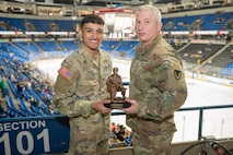 Spc. Alexavier L. Munoz (left) accepted the Tobyhanna Army Depot Outstanding Active-Duty Servicemember award from Maj. Joseph A. Page (right).