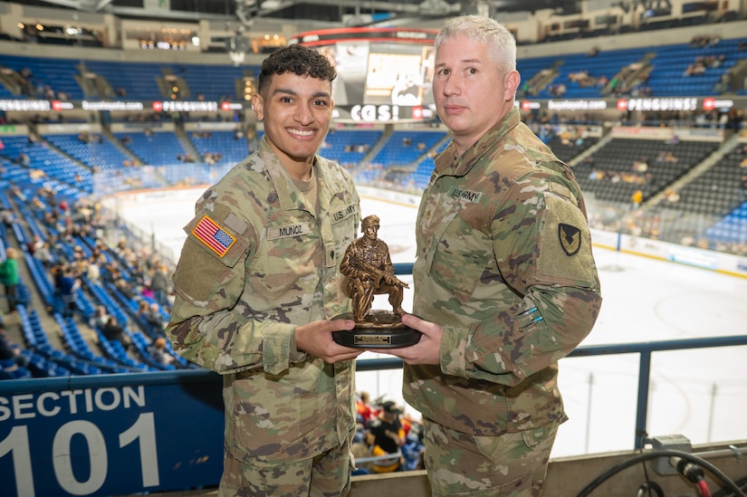 Spc. Alexavier L. Munoz (left) accepted the Tobyhanna Army Depot Outstanding Active-Duty Servicemember award from Maj. Joseph A. Page (right).
