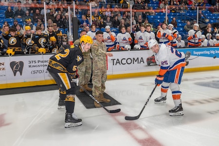 Spc. Alexavier L. Munoz prepares to perform the ceremonial puck drop.