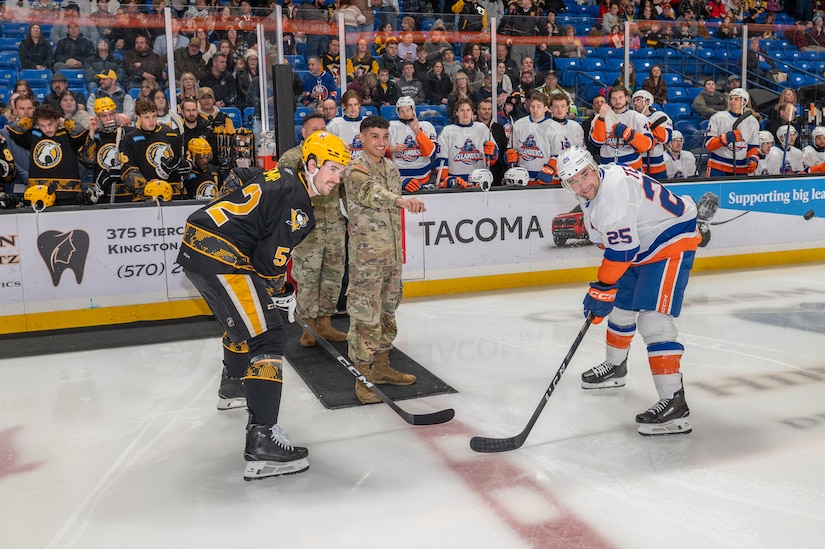 Spc. Alexavier L. Munoz prepares to perform the ceremonial puck drop.