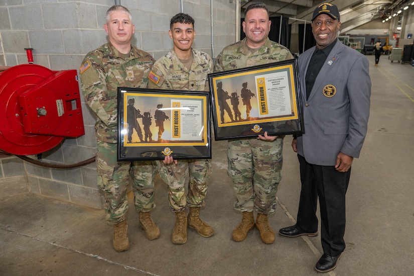 Posing for a photo following the presentation are (from left) Maj. Joseph A. Page, Spc. Alexavier L. Munoz, Sgt. 1st Class Jashual Vazquez, and Kelvin L. Spencer of AUSA.