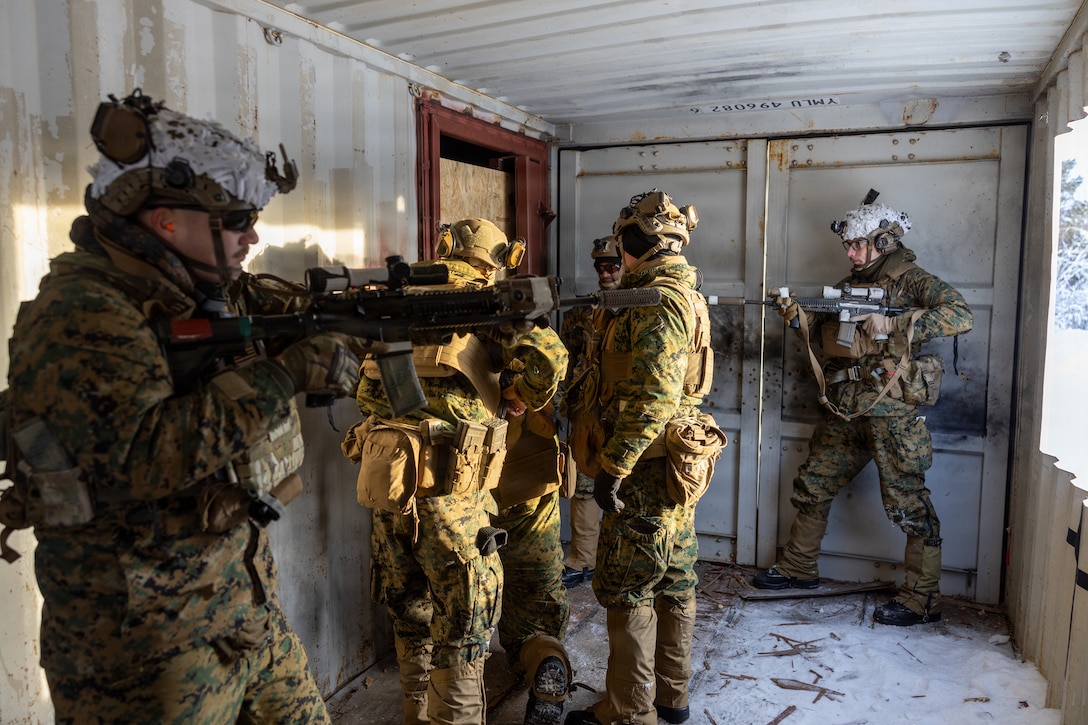U.S. Marines with 2nd Battalion, 6th Marine Regiment, 2nd Marine Division, and 2nd Combat Engineer Battalion, 2nd MARDIV, set up a breaching charge on a door during an urban demolition range in Setermoen, Norway, Feb. 19, 2026. A key component of NATO's enhanced vigilance activity Arctic Sentry, exercise Cold Response 26 is a Norwegian-led winter military exercise designed to enhance collective defense capabilities and ensure U.S. readiness to rapidly deploy and seamlessly operate alongside NATO Allies in challenging arctic conditions. (U.S. Marine Corps photo by Cpl. Apollo Wilson)