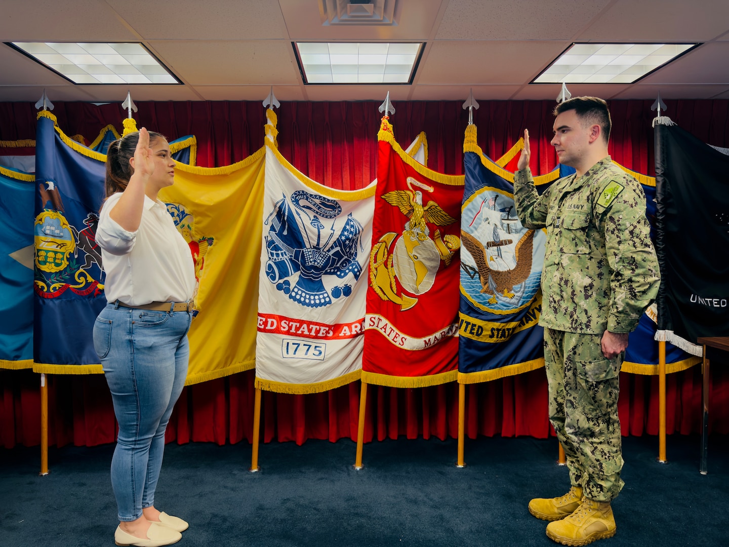 (L) Yvette Meeches, Fort Dix MEPS lead human resources assistant, takes the oath of enlistment into the Army Reserve.Meeches joined the Army Reserve as a 38B, civil affairs specialist and will continue to support the MEPS after initial entry training.