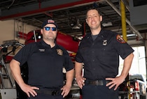 Two 628th CES Fire and Fighters pose for a portrait after an interview.