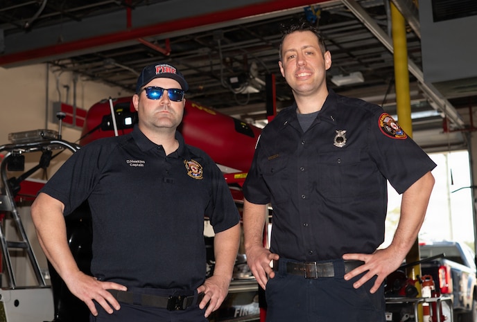 Two 628th CES Fire and Fighters pose for a portrait after an interview.