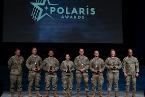 U.S. Space Force Chief of Space Operations Gen. Chance Saltzman, left, and Chief Master Sgt. of the Space Force John Bentivegna, right, pose with the 2025 Polaris Award service-level recipients during an awards ceremony at the Air Force Association’s Warfare Symposium in Aurora, Colo., Feb. 23, 2026. The awards are based on the four Guardian Values of Character, Connection, Commitment and Courage. (U.S. Air Force photo by Senior Airman Malia Heemsoth)