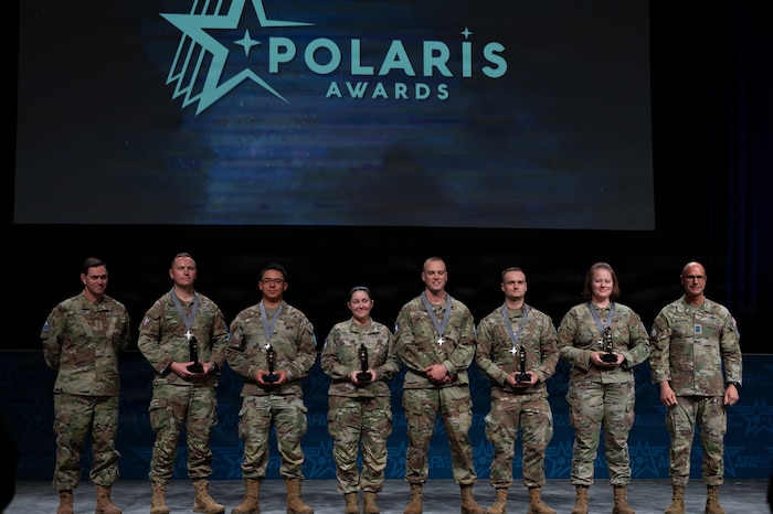 U.S. Space Force Chief of Space Operations Gen. Chance Saltzman, left, and Chief Master Sgt. of the Space Force John Bentivegna, right, pose with the 2025 Polaris Award service-level recipients during an awards ceremony at the Air Force Association’s Warfare Symposium in Aurora, Colo., Feb. 23, 2026. The awards are based on the four Guardian Values of Character, Connection, Commitment and Courage. (U.S. Air Force photo by Senior Airman Malia Heemsoth)