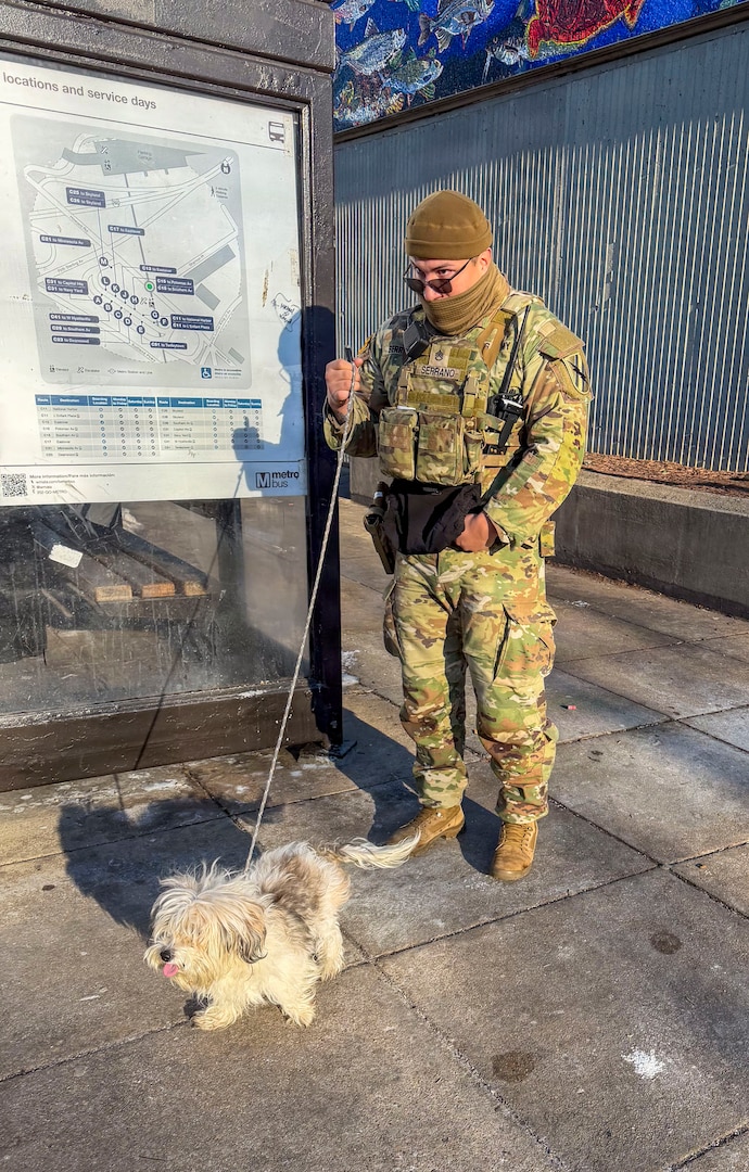 U.S. Army Staff Sgt. Cesar Serrano, Georgia National Guard, cares for a lost dog at the Anacostia Metro Station in Washington, D.C., Feb. 9, 2026, before it was safely returned to its owner. Approximately 2,700 National Guard members are supporting the mission, providing critical assistance to the Metropolitan Police Department to help ensure the safety of residents, commuters and visitors throughout the District. (U.S. Army National Guard photo by 1st Lt. David Okonofua)