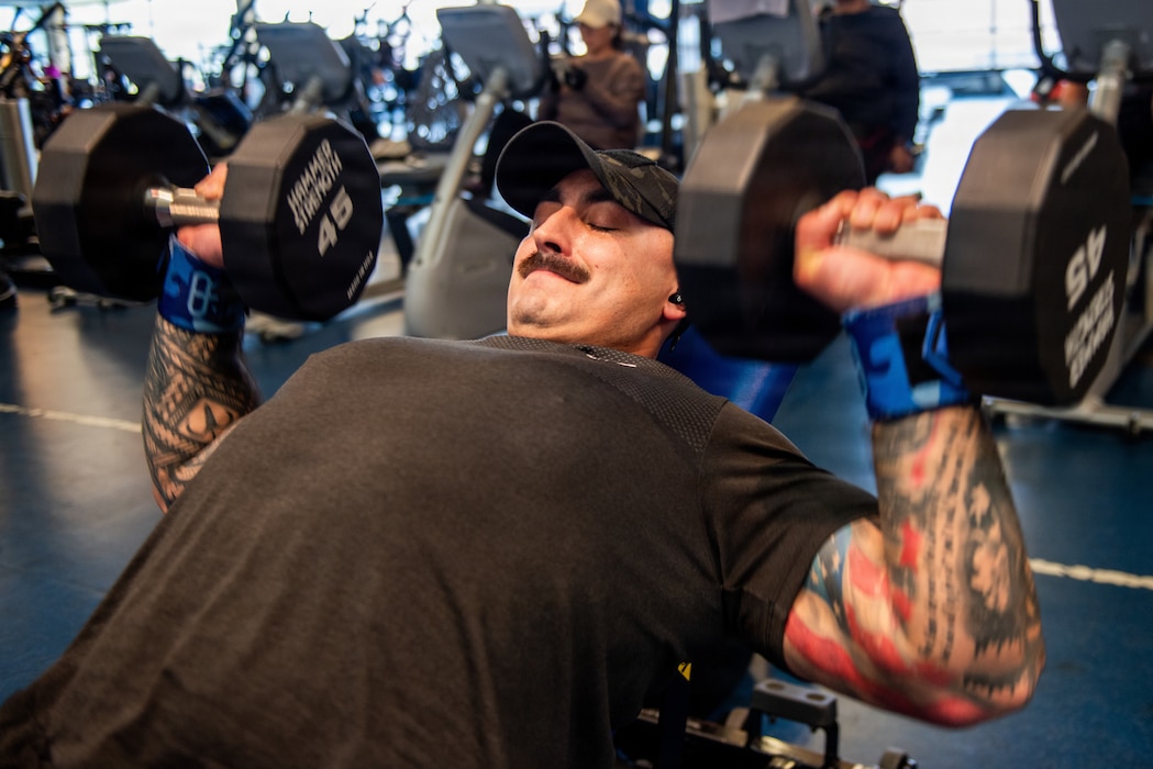 Airman performs chest press