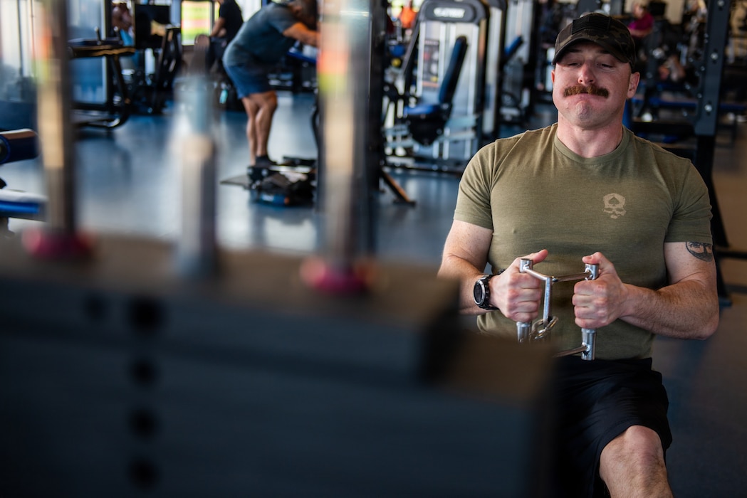 Patron performs cable rows