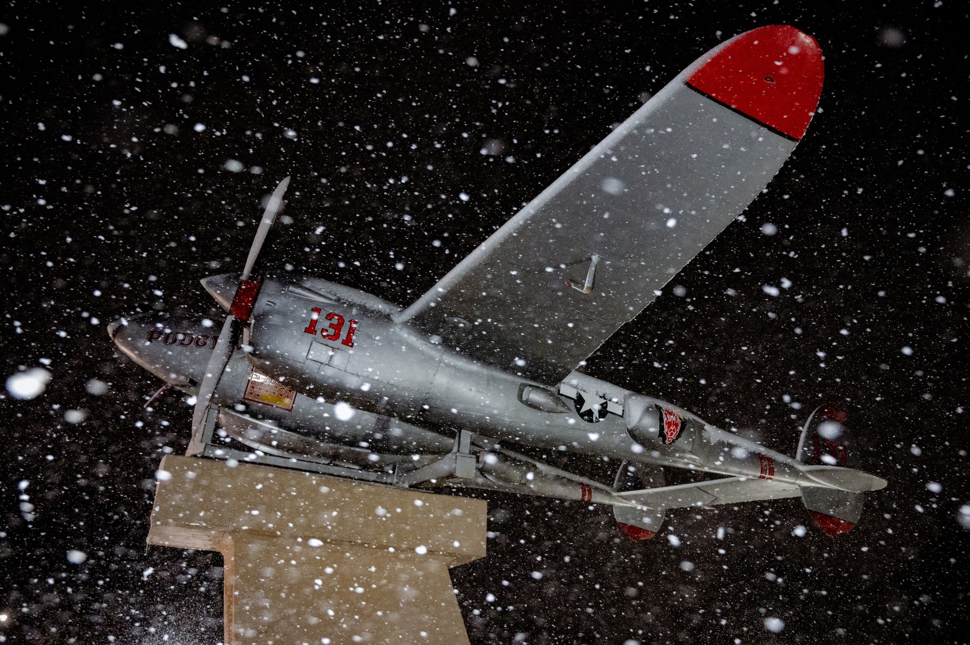 The Lockheed P-38 Lightning, “Pudgy”, static display is covered in snow from Winter Storm Hernando on Joint Base McGuire-Dix-Lakehurst, N.J., Feb 22, 2026. Heavy snowfall from the winter storm tested the installation’s dedication to maintaining operational readiness through clearing roads and runways, as well as keeping mission-critical infrastructure operational. (U.S. Air Force photo by Airman 1st Class Matthew Almazan)