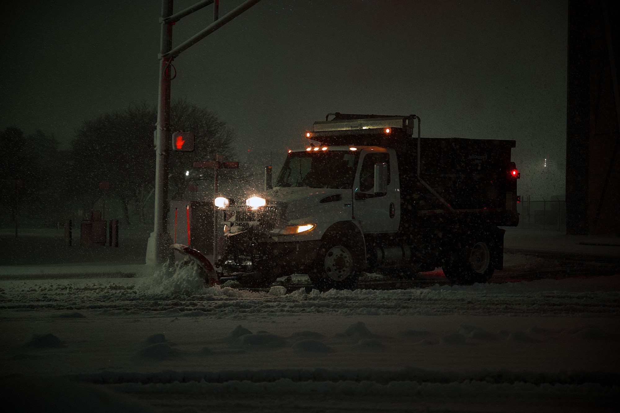 U.S. Air Force members clear roads using a snowplow at Joint Base McGuire-Dix-Lakehurst, N.J., Feb. 22, 2026. Even as Winter Storm Hernando impacted the area, teams maintained operational readiness across flight lines, roadways and support facilities. (U.S. Air Force photo by 2nd Lt. Gabriel Davenport)