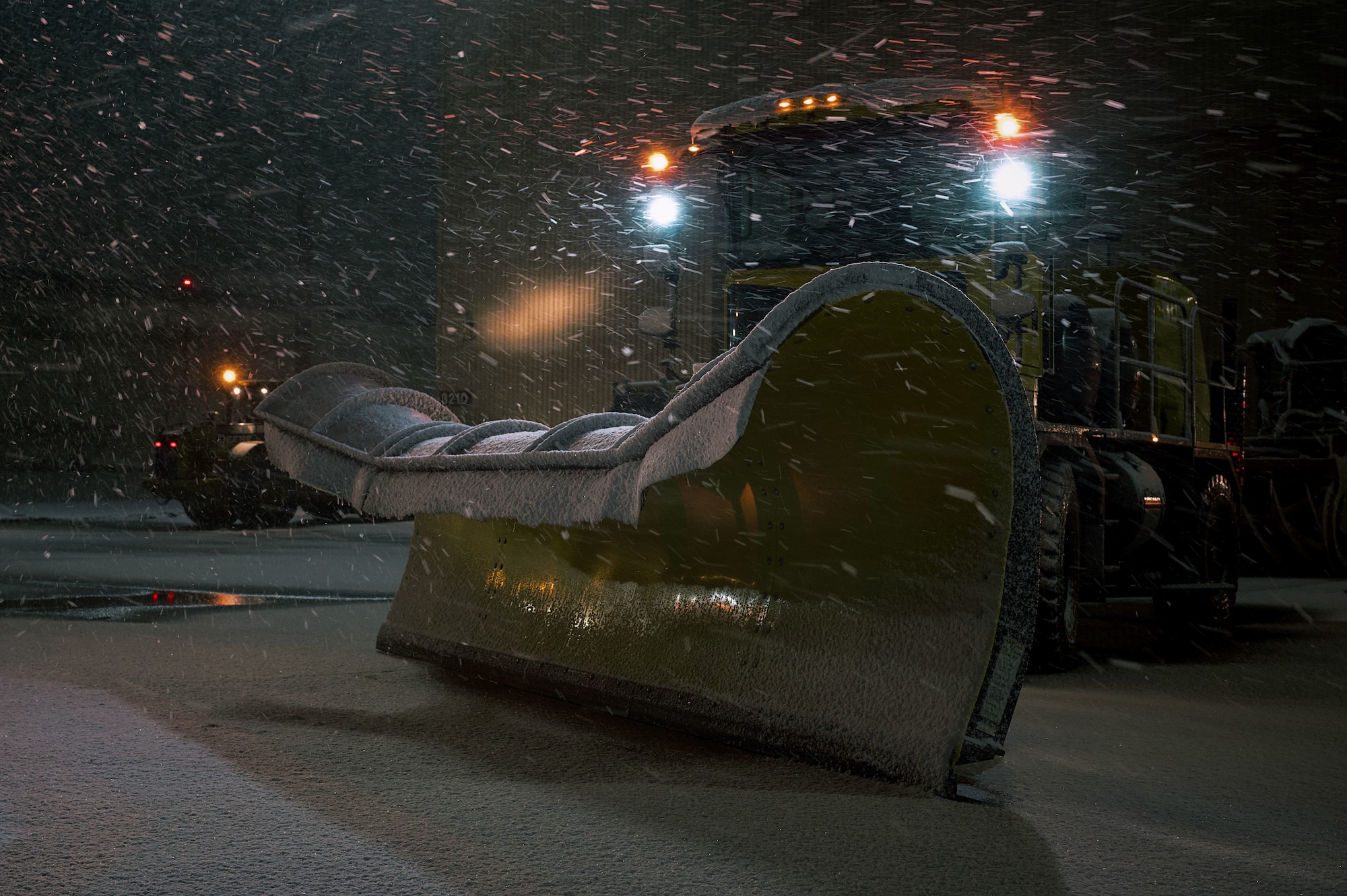 A snowplow sits idle in preparation to clear runways at Joint Base McGuire-Dix-Lakehurst, N.J., Feb 22, 2026. Even as Winter Storm Hernando impacted the area, teams maintained operational readiness across flight lines, roadways and support facilities. (U.S. Air Force photo by 2nd Lt. Gabriel Davenport)