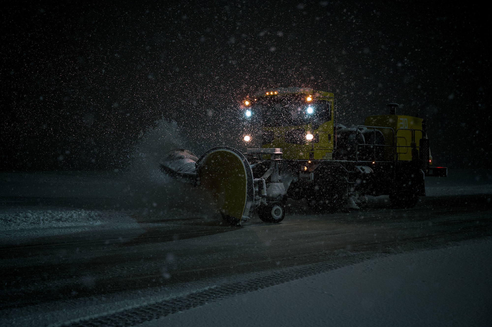 U.S. Air Force Staff Sgt. Yadrian Perez Rodriguez, 87th Civil Engineer Squadron heavy equipment supervisor, clears taxiways at Joint Base McGuire-Dix-Lakehurst, N.J., Feb 22, 2026. Even as Winter Storm Hernando impacted the area, teams maintained operational readiness across flight lines, roadways and support facilities. (U.S. Air Force photo by 2nd Lt. Gabriel Davenport)