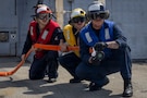 U.S. Navy Seaman Carson Barber, left, Boatswain’s Mate 2nd Class Carson Warren, middle, and Boatswain’s Mate 2nd Class Caleb Lebreton, assigned to Arleigh Burke-class guided-missile destroyer USS Delbert D. Black (DDG 119), man the hose during a flight deck firefighting drill in the Red Sea, Feb. 16, 2026. Delbert D. Black is deployed to the U.S. 5th Fleet area of operations to support maritime security and stability in the Middle East. (U.S. Navy photo by Mass Communication Specialist 1st Class Wendy Arauz)
