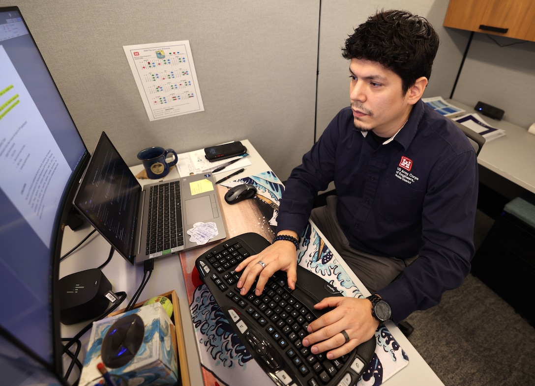 Picture of a man typing on a keyboard