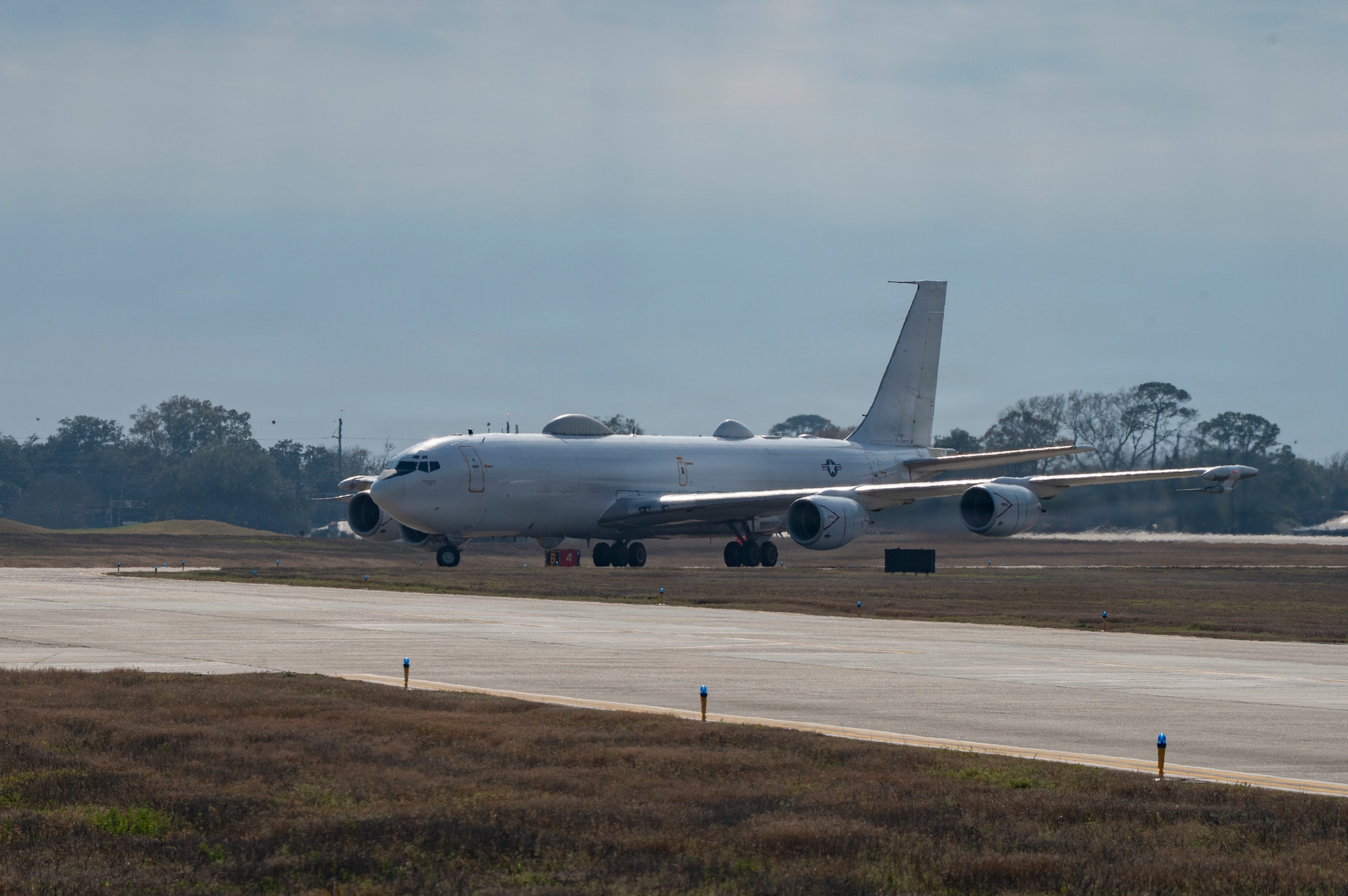 A white plane on a runway.