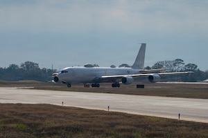 A white plane on a runway.