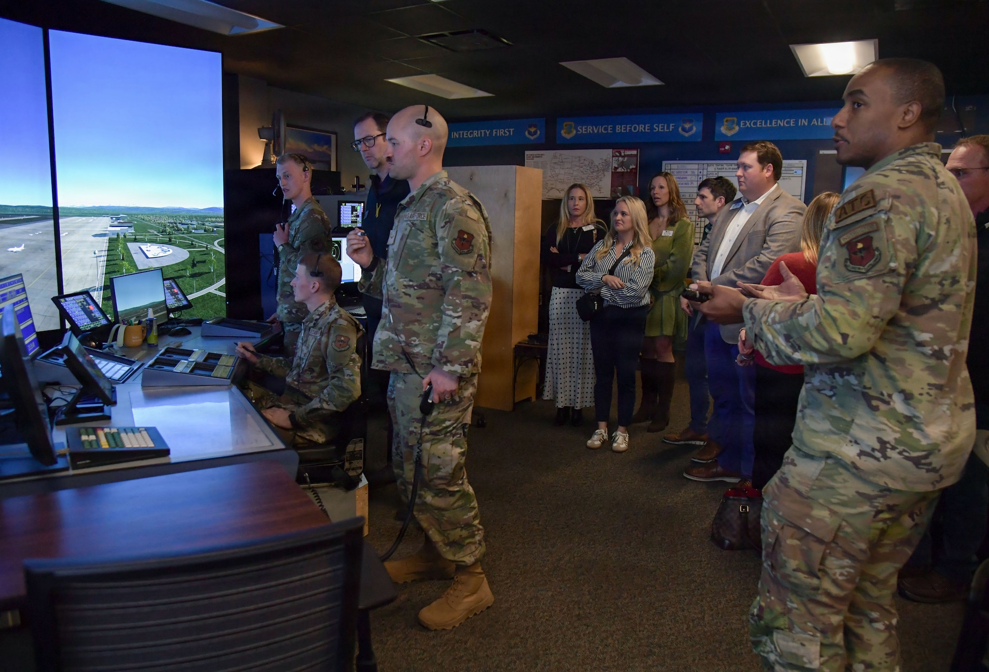 A group of people look at a training monitor.