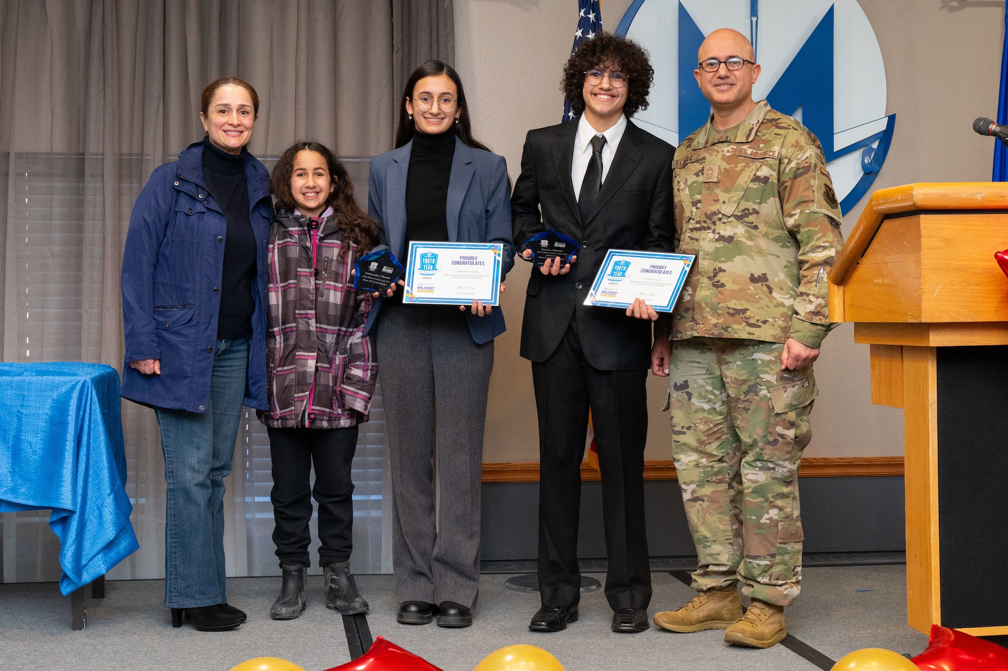 Fatimazahra Elouab, a sophomore at Minot North High School, poses for a photo with her family after being recognized as the 2026 Military Youth of the Year at Minot Air Force Base, North Dakota, Feb. 23, 2026. The Youth of the Year program recognizes outstanding high school students for academic achievement, leadership and service within the military community. (U.S. Air Force photo by Airman 1st Class Vincent Padilla)