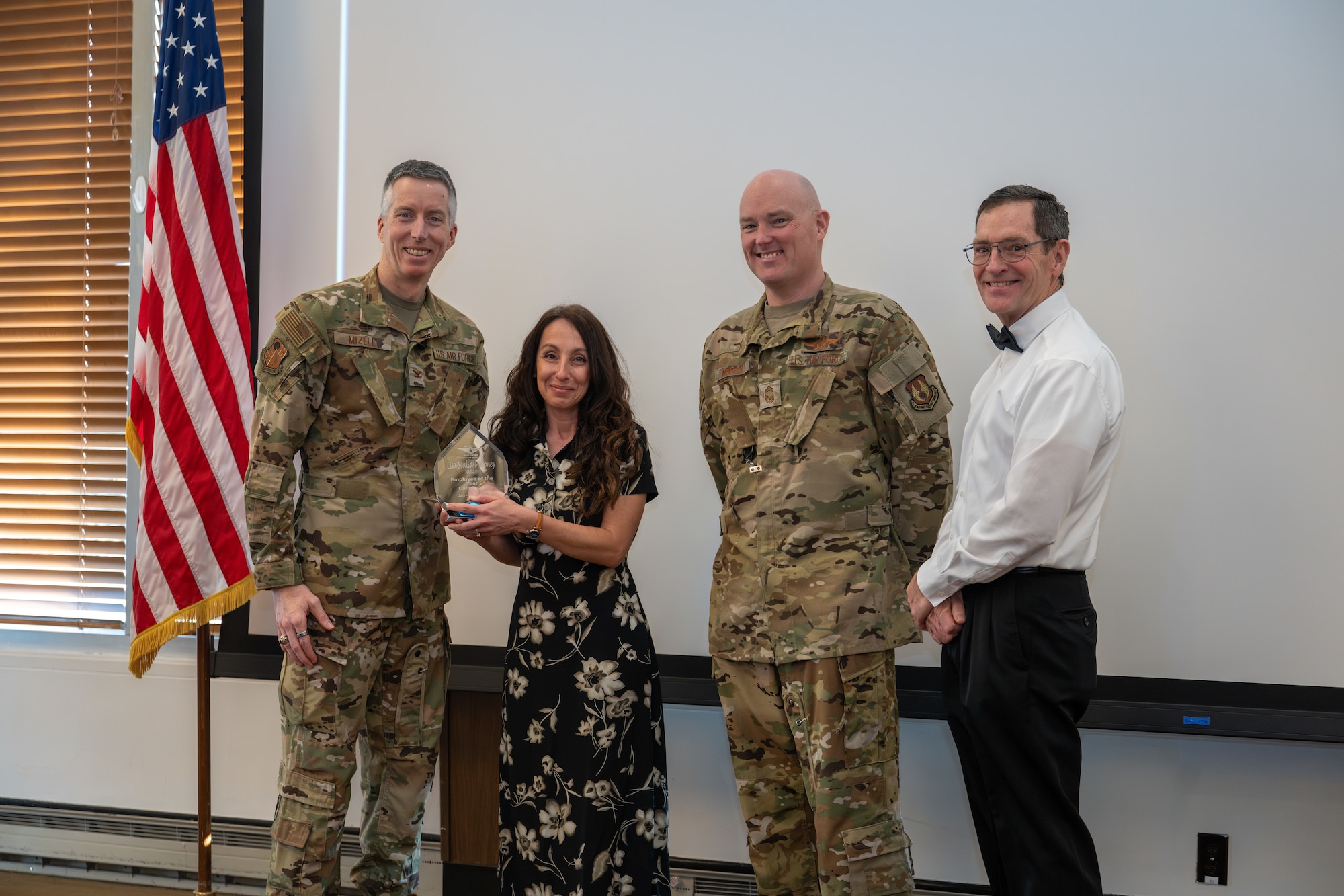 Lisa Scalia-Maloney with Test Support Division – Services accepts the award for Non-appropriated Fund Category I Civilian of the Year from Arnold Engineering Development Complex Commander Col. Grant Mizell during the AEDC Annual Awards ceremony Feb. 20, 2026, at Arnold Air Force Base, Tenn. Also pictured is Chief Master Sgt. Evan McCoy and AEDC Deputy Director Kevin Muckerheide. (U.S. Air Force photo by Keith Thornburgh)