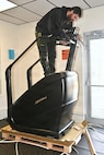 An employee of Coastal Fit Supply in Mays Landing, New Jersey, sets up a new piece of gym equipment at Blue Mountain Sports Area at Fort Indiantown Gap, Pennsylvania, on Feb. 26, 2026. (Pennsylvania National Guard photo by Brad Rhen)