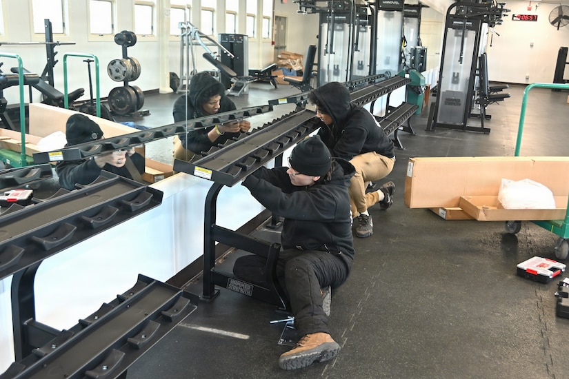 Employees of Coastal Fit Supply in Mays Landing, New Jersey, install a new piece of gym equipment at Blue Mountain Sports Area at Fort Indiantown Gap, Pennsylvania, on Feb. 26, 2026. (Pennsylvania National Guard photo by Brad Rhen)
