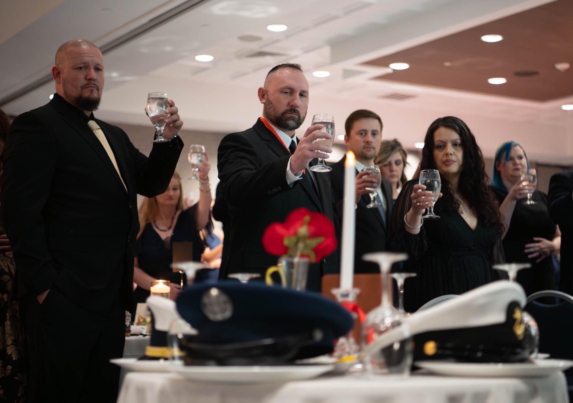 Men and women toasting the POW/MIA table